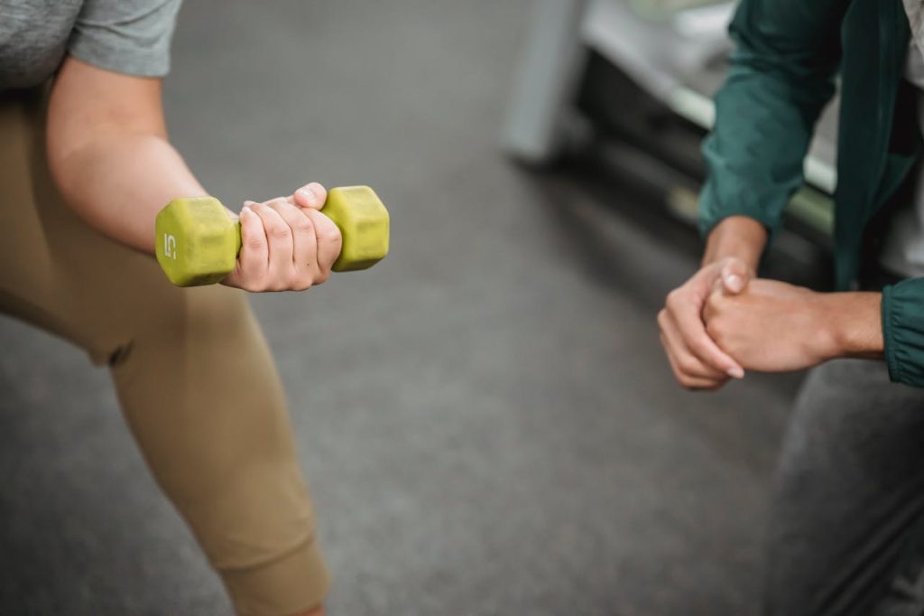A focused close-up of a personal training session with dumbbells, emphasizing effort.